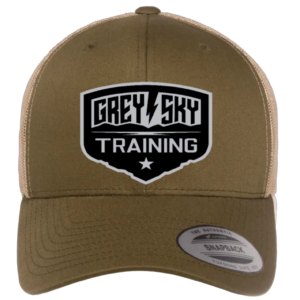 A tan and green hat with the Grey Sky Training logo